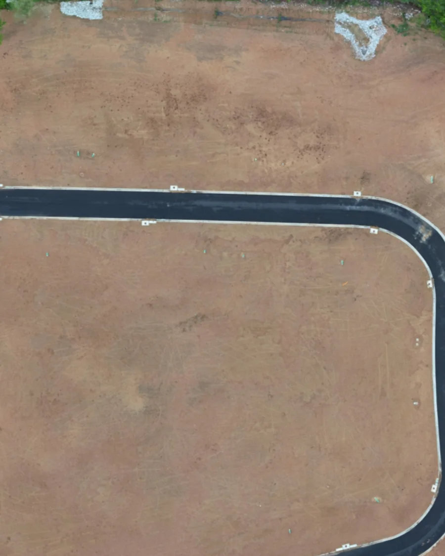 The same subdivision on an earlier flight: graded lots and fresh asphalt, no houses yet.